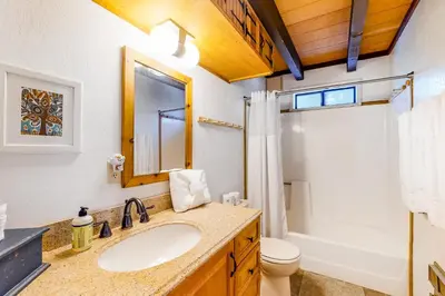 a bathroom with a sink and a toilet and a mirror at Hillside Haven in Soda Springs