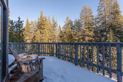 a deck with a wooden fence and a bench at Hillside Haven in Soda Springs