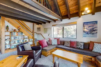 a living room with couches and a table at Hillside Haven in Soda Springs