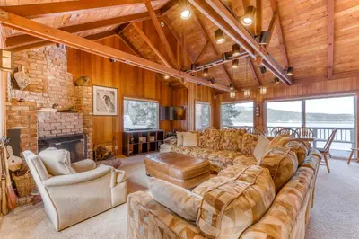 a living room with a large couch and a fireplace at Beaver Cove Lodge in Truckee
