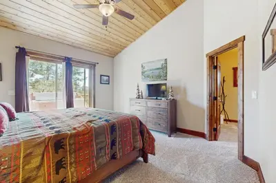 a bedroom with a bed and a dresser and a television at Fabian Holidays in Tahoe City