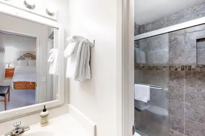 a bathroom with a shower and a sink and a mirror at Crestview 36 in Mammoth Lakes