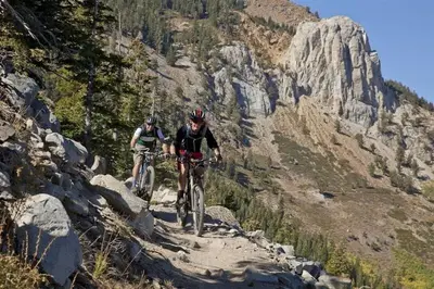 two people riding bikes on a mountain trail at Woodwinds 19 in Mammoth Lakes