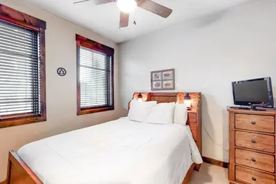 a bedroom with a bed and a flat screen tv at Woodwinds 19 in Mammoth Lakes