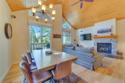 a dining room with a table and a fireplace at Central Townhome Less Than 1 Mi to The Village at Mammoth! in Mammoth Lakes