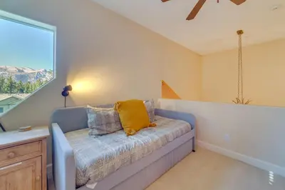 a couch in a room with a large window at Central Townhome Less Than 1 Mi to The Village at Mammoth! in Mammoth Lakes