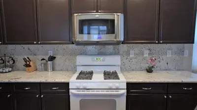 a kitchen with a white stove and a microwave at Modern Luxury Living, relax and enjoy your stay! in Rancho Cordova