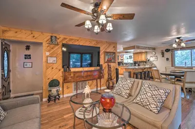 a living room with a couch and a table at Near Hiking Trails Cabin with Deck in Pioneer! in Pioneer