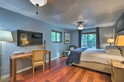 a bedroom with a bed and a desk and a tv at Near Hiking Trails Cabin with Deck in Pioneer! in Pioneer