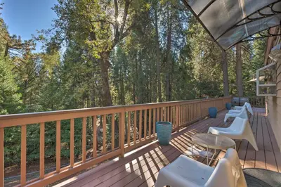 a deck with white chairs and tables and trees at Near Hiking Trails Cabin with Deck in Pioneer! in Pioneer