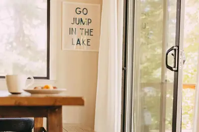 go jump in the lake sign on a window in a room at Family Cabin in Blue Lake Springs, Near Town! in Arnold