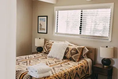 a bedroom with a bed with two lamps and a window at Family Cabin in Blue Lake Springs, Near Town! in Arnold