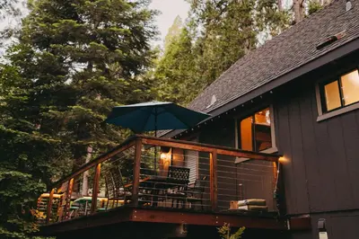 a balcony with an umbrella on a house at Family Cabin in Blue Lake Springs, Near Town! in Arnold