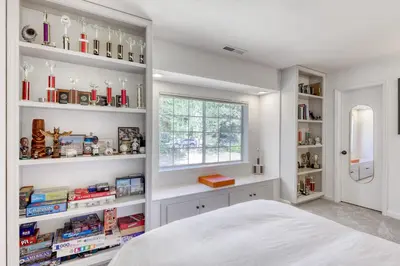 a bedroom with white shelves and a window and a bed at Captains Quarters Retreat in Zephyr Cove