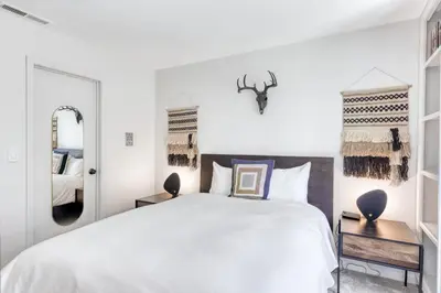 a bedroom with a large white bed and a mirror at Captains Quarters Retreat in Zephyr Cove