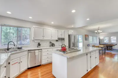 a kitchen with white cabinets and a hardwood floor at Captains Quarters Retreat in Zephyr Cove
