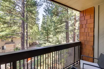 a balcony with a view of the trees at Walk to Ski Shuttle Incline Village Condo in Incline Village