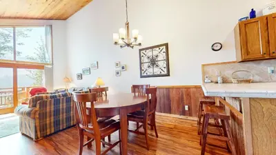 a kitchen and dining room with a table and chairs at Meadow Ridge #28 condo in Mammoth Lakes