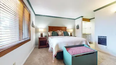 a bedroom with a large bed and a window at Meadow Ridge #28 condo in Mammoth Lakes