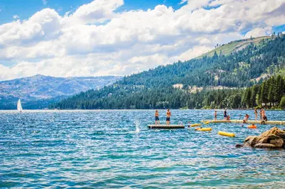 a group of people standing on a dock in a lake at Meadowview in Truckee