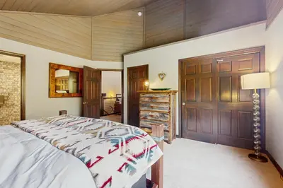 a bedroom with a bed and a wooden door at Meadowview in Truckee