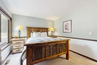 a bedroom with a large bed with a wooden frame at Meadowview in Truckee