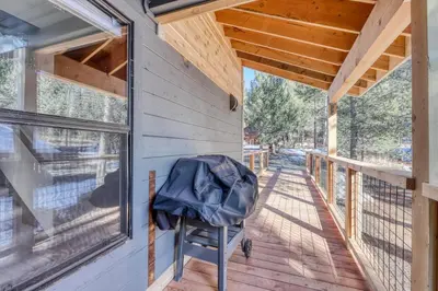 a backpack sits on the porch of a tiny house at Meadowview in Truckee