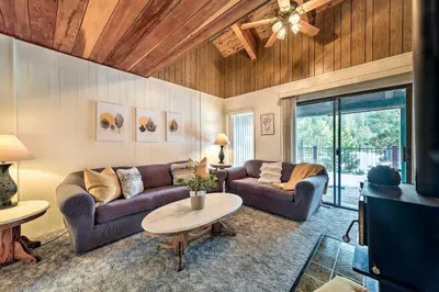 a living room with two couches and a table at Pinecrest Retreat with Fireplace! in Pinecrest
