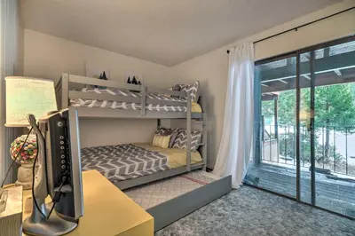 a bedroom with bunk beds and a desk and a window at Pinecrest Retreat with Fireplace! in Pinecrest