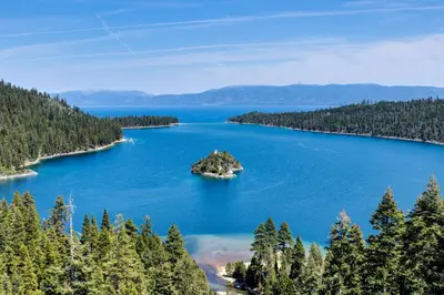 an island in the middle of a lake with trees at Tahoe Treetop Escape in Stateline