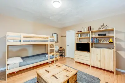 a bedroom with two bunk beds and a tv at Tahoe Treetop Escape in Stateline