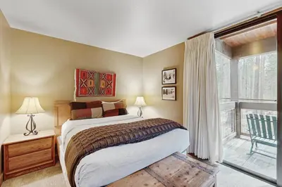 a bedroom with a bed and a large window at Aspen Grove Getaway in Kingswood Estates