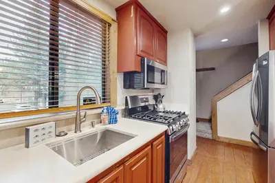 a kitchen with a sink and a stove at Aspen Grove Getaway in Kingswood Estates