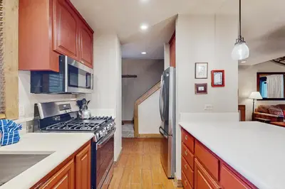 a kitchen with wooden cabinets and a stove top oven at Aspen Grove Getaway in Kingswood Estates