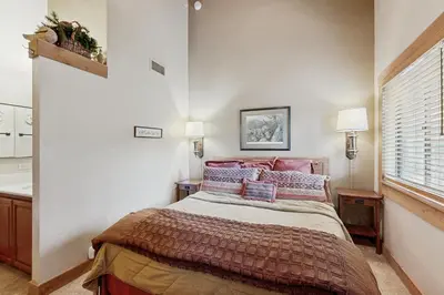a bedroom with a bed with pillows and a window at Aspen Grove Getaway in Kingswood Estates