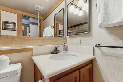 a bathroom with a sink and a mirror at Aspen Grove Getaway in Kingswood Estates