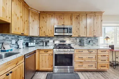 a kitchen with wooden cabinets and stainless steel appliances at Heavenly Hideaway in Stateline