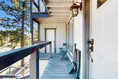 a porch of a house with a blue railing at Heavenly Hideaway in Stateline