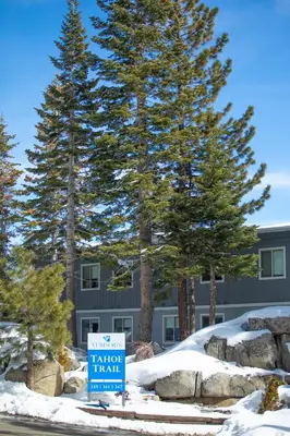 a sign for a ranger inn in front of trees at Tahoe Trail Resort in Stateline