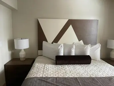 a bedroom with a large bed with white pillows at Tahoe Trail Resort in Stateline