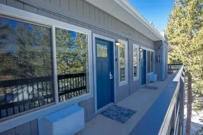 a front porch with blue doors and windows at Tahoe Trail Resort in Stateline