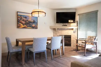 a dining room with a table and chairs and a fireplace at Tahoe Trail Resort in Stateline