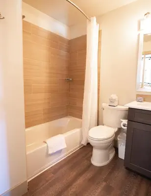 a bathroom with a tub and a toilet and a sink at Tahoe Trail Resort in Stateline