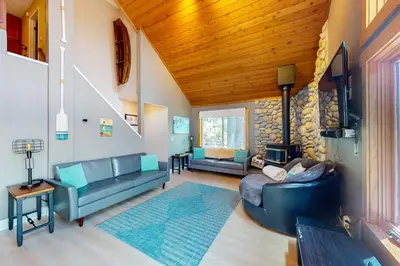 a living room with two couches and a fireplace at Ridgeline Panorama in Truckee