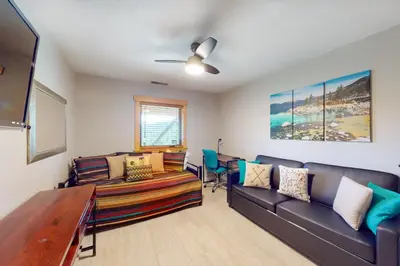 a living room with couches and a flat screen tv at Ridgeline Panorama in Truckee