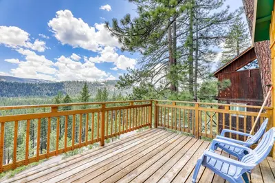 a deck with two chairs and a cabin at Ridgeline Panorama in Truckee