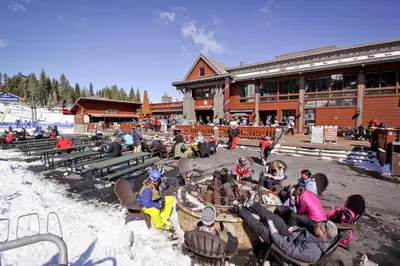 a group of people sitting in chairs in front of a lodge at Snowdream in Ponderosa Fairway Estates