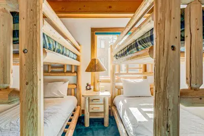 a bedroom with two bunk beds and a desk at Snowdream in Ponderosa Fairway Estates