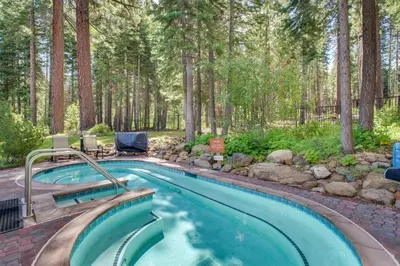 a swimming pool in the middle of a forest at Snowdream in Ponderosa Fairway Estates