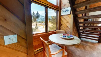 a room with a table and a window in a cabin at Snowcreek III #448 condo in Mammoth Lakes
